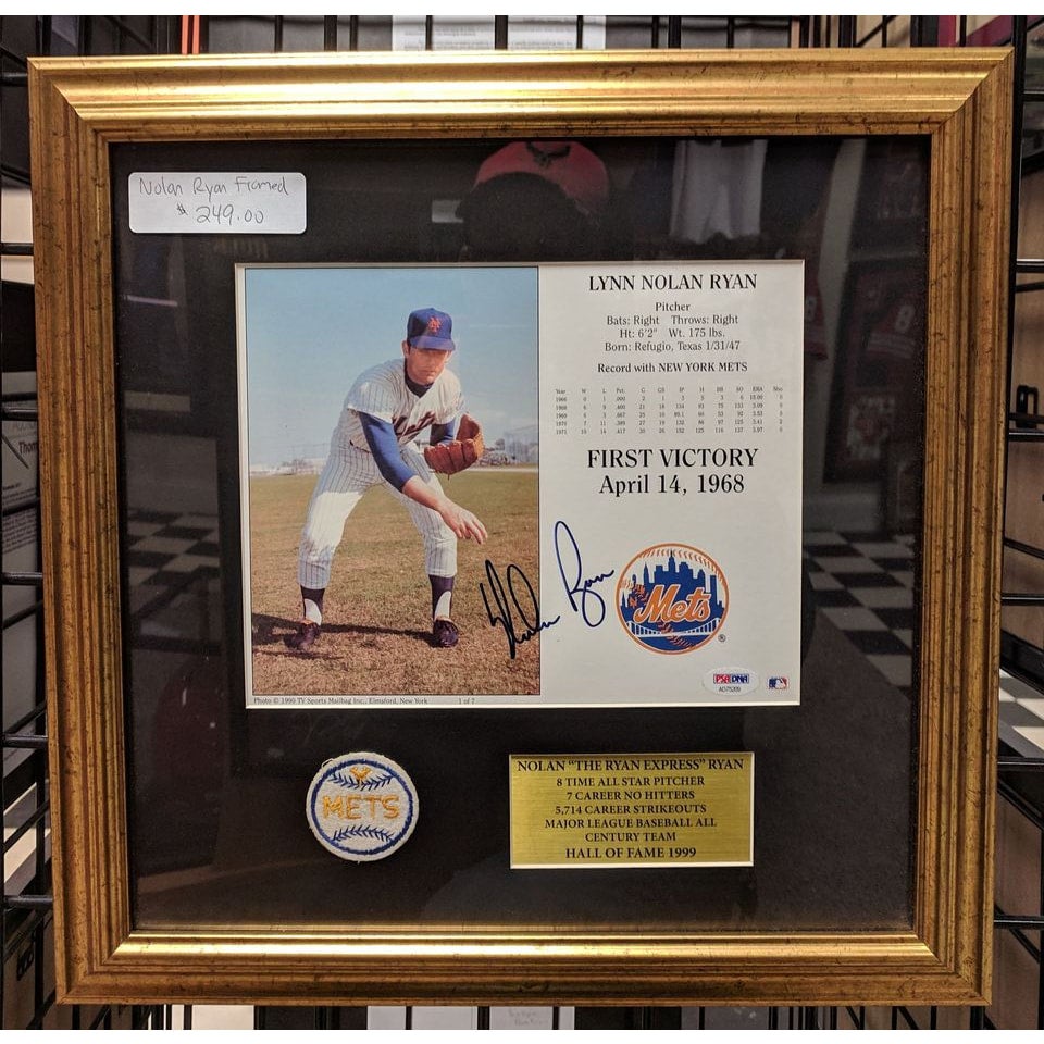 Nolan Ryan's signature on a custom-framed baseball, showcasing the distinctive looping script that defines his autograph style.